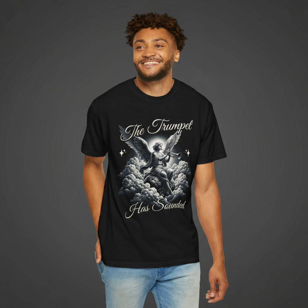 Man wearing a black t-shirt with an angel graphic and text on a dark
background